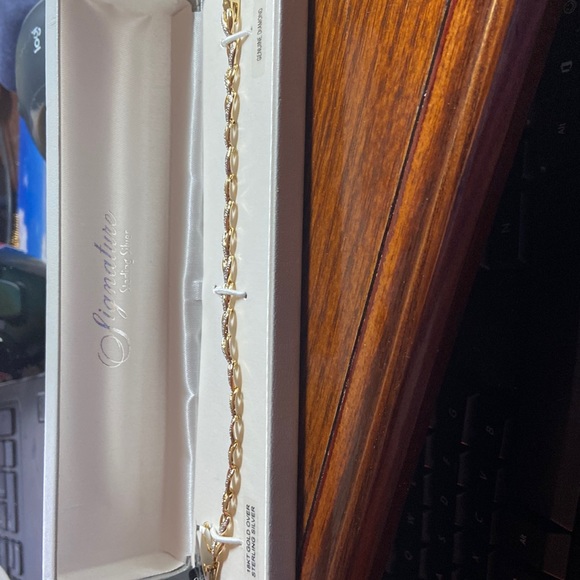 7” gold over silver bracelet. Small diamond chips throughout. Very pretty. - Picture 2 of 7